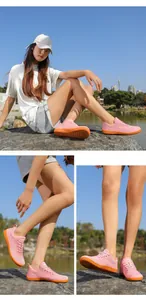 Detail von pinkem Mesh-Gewebe und orangefarbener rutschfester Gummisohle der Wanderschuhe