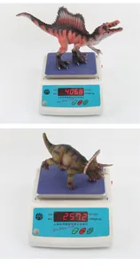Detailed comparison of Spinosaurus and Triceratops toy weights on a scale
