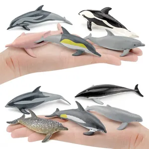 Realistic mini dolphin and whale figure collection set held in hand for size