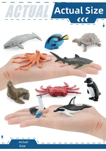 Close-up showing actual size of miniature marine animal toys held in a human hand