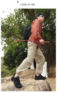 Men's wide-toe hiking shoes on rocky terrain showing professional non-slip thick outsoles