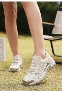 Outdoor hiking shoes shown on grass with breathable mesh and anti-slip thick soles