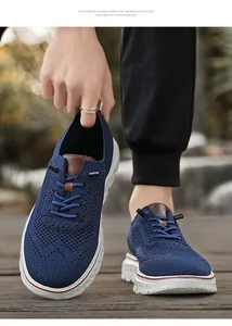 Detail of blue breathable mesh sneakers with brown leather tongue and white thick soles