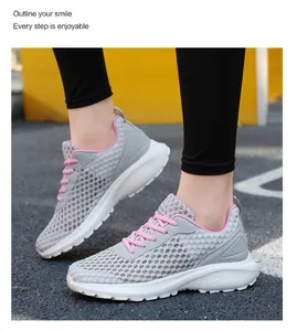 Dettaglio scarpe da corsa in mesh grigio traspirante con lacci rosa da donna