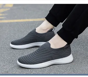 Close-up of dark grey slip-on walking shoe featuring breathable knit wave texture