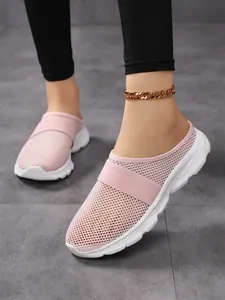 Detail of pink mesh mule sneakers with thick white soles and elastic strap for women