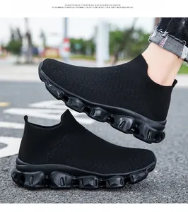 Detail of breathable black mesh upper and wavy thick sole on sock-style sneakers