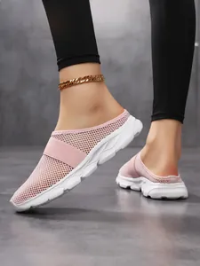 Close-up of pink mesh mule sneakers with thick white soles and breathable mesh upper