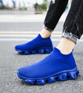 On-foot macro of breathable royal blue flyknit sneakers with hollow cushioning sole