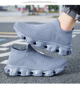 Detail of grey-blue knit walking shoes featuring breathable mesh and hollow out sole