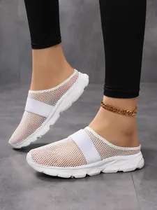 Close-up of white mesh mules for women with breathable fabric and athletic wedge sole