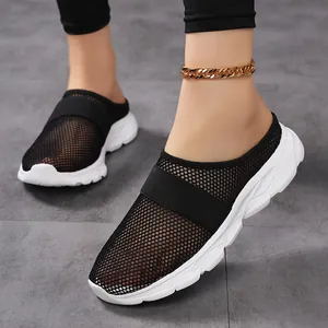 Women's black mesh sneaker mules with breathable fabric and thick white foam soles