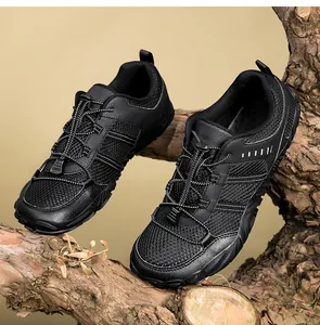 Close-up of the breathable mesh upper and non-slip rubber sole of the black outdoor shoes