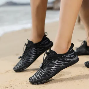 Close-up of quick-dry wading shoe with breathable mesh and adjustable drawstring on beach