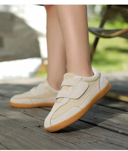 Detail view of khaki mesh upper and double velcro straps on retro leisure sneakers