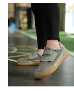 Close-up of kids' retro mesh sneakers with double velcro straps on a soft gum sole