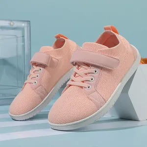 Detail of baby pink knit toddler shoe with mesh texture and white non-slip rubber sole