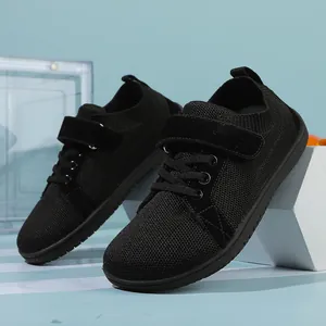 Detailed close-up of breathable black mesh baby sneakers with secure velcro strap