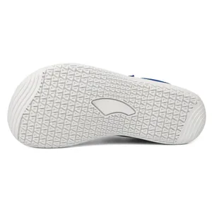 Detail of baby walking shoes showing white anti-slip rubber sole with triangle patterns