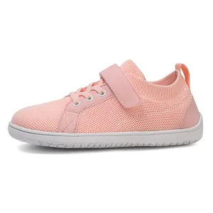 Detailed side view of pink breathable mesh kids sneaker with Velcro strap and rubber sole