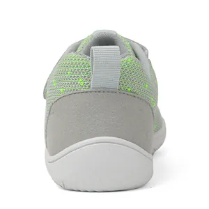 Close-up back view of grey mesh baby shoes with green stitching and heel pull tab