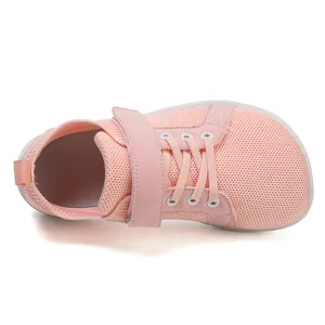 Detail of pink breathable mesh kids sneakers with wide toe box and velcro closure
