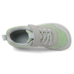 Detail of grey kids breathable mesh shoe with green dots and durable protective toe cap