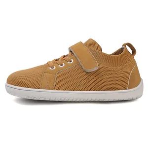 Detail of children's breathable flyknit sneakers with velcro strap and suede accents