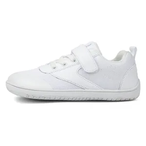 Detail of white wide-toe toddler shoe featuring breathable mesh and durable rubber sole