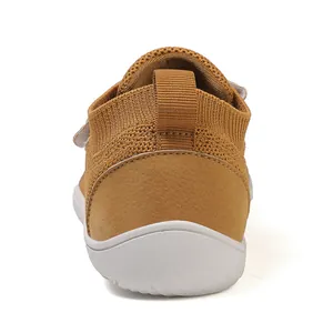 Rear view of tan kids' knit sneakers with wide-toe fit and white supportive rubber soles