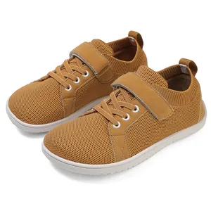 Detail of kids breathable knit barefoot shoes with hook-and-loop closure in yellow