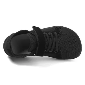 Detailed view of kids barefoot sneakers with black mesh fabric and velcro closure