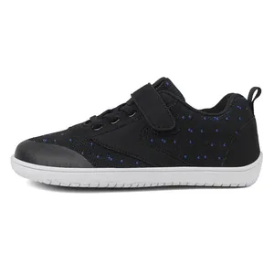 Detail of baby barefoot shoes with breathable black knit mesh and secure velcro strap
