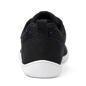 Rear view of black knit toddler shoes with blue dots and breathable mesh upper