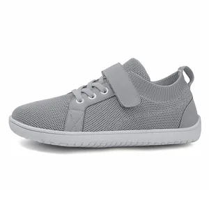 Detail of grey flyknit kids sneaker featuring mesh fabric and adjustable velcro strap