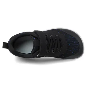 Top view of children's wide-toe barefoot sneakers with blue dots and Velcro straps