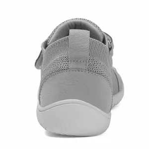 Macro view of grey knitted kids sneakers showing breathable mesh and durable heel pull tab