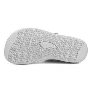 Detailed bottom view of light grey anti-slip outsole with triangular traction patterns