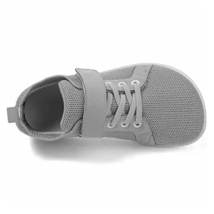 Detail view of breathable grey mesh sneakers with velcro strap and wide toe box for kids