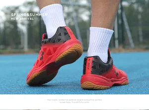 Detailed view of red badminton shoes with non-slip gum rubber sole and MRK logo