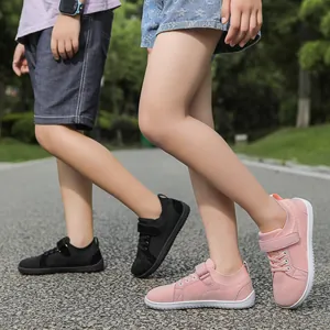 Kids breathable mesh sneakers with velcro straps shown in pink and black on outdoor path