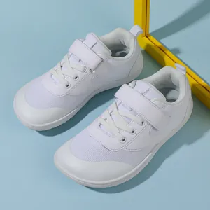Overhead view of white wide-toe kids sneakers with mesh fabric and velcro closure