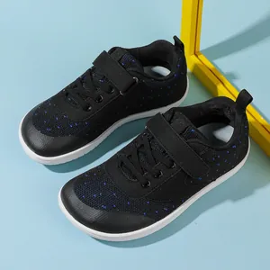 Top view of baby wide-toe shoes with black mesh, blue stars, and velcro straps