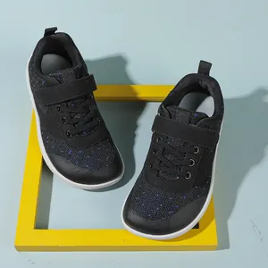 Detail view of breathable black mesh baby shoes with blue dots and secure velcro straps