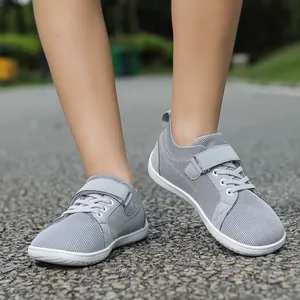 Close-up of kids' breathable grey mesh sneakers with velcro strap and white lightweight sole