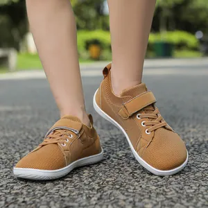 Detailed close-up of breathable mesh fabric and velcro strap on kids athletic shoes
