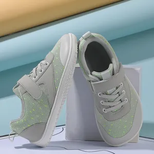 Close-up of kids breathable grey sneakers with green mesh and non-slip rubber soles