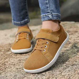 Kids mustard yellow breathable mesh sneakers featuring dual velcro and lace-up closure