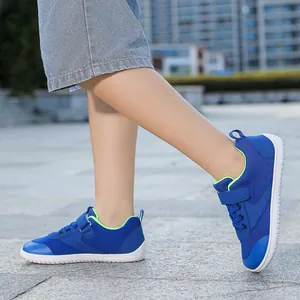 Detail view of navy blue mesh toddler walking shoes with lime green lining and velcro strap