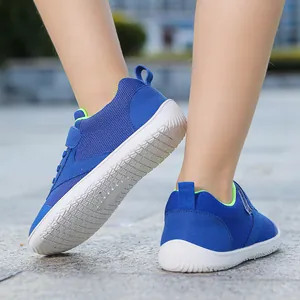 Detail shot of blue children's walking shoes with non-slip soles and velcro straps